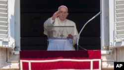 Pope Francis delivers his blessing as he recites the Angelus noon prayer from the window of his studio overlooking St.Peter's Square, at the Vatican, Sunday, July 17, 2022. (AP Photo/Andrew Medichini)