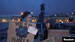FILE - Activists with signs are an environmental rally, part of the Global Climate Strike, in Saint Petersburg, Russia, Sept. 20, 2019.