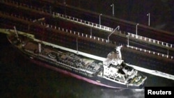 A 2,591-tonne tanker, which is sent by strong wind caused by Typhoon Jebi, crashes into a bridge connecting Kansai airport, which is built on a man-made island in a bay, to the mainland, in Izumisano, western Japan, in this photo taken by Kyodo, Sept. 4, 