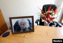 A photograph of late Nancy Hatch Dupree, an American historian, and a bouquet of flowers are seen in her office after she passed away, in Afghanistan Centre at Kabul University (ACKU), in Kabul, Sept. 10, 2017.