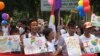 Participants wave rainbow flags during Vietnam’s first Gay Pride parade, Hanoi, August 5, 2012. (Marianne Brown/VOA)