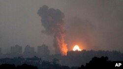 Fire and smoke rise following an Israeli airstrike in the Gaza Strip, as seen from southern Israel, on Oct. 28, 2023.