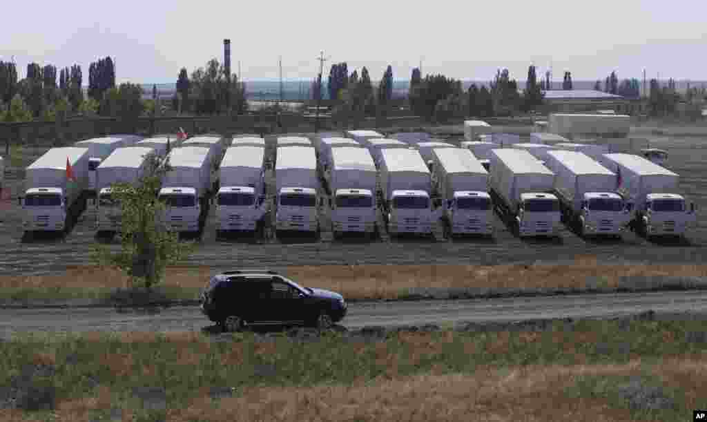 A convoy of white trucks with humanitarian aid parked in a field about 28 kilometers from the Ukrainian border in Rostov-on-Don region, Russia, Aug. 14, 2014.