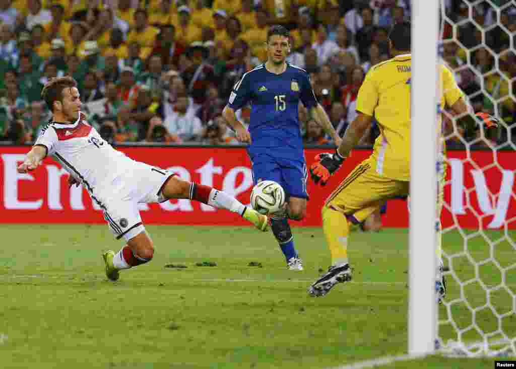 Germany's Mario Goetze scores during extra time at the Maracana stadium in Rio de Janeiro, July 13, 2014.