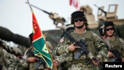Georgian servicemen stand at attention during an opening ceremony of the NATO-led military exercises "Noble Partner 2018" at Vaziani military base outside Tbilisi, Georgia, Aug. 1, 2018.