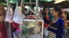 Garment workers buy food during a lunch break on national road #2 in Meanchey district, Phnom Penh, Cambodia. (Photo: Phorn Bopha/VOA Khmer) 
