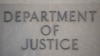 The sign of the U.S. Department of Justice building is seen on its facade, in Washington, Jan. 28, 2019.
