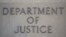 The sign of the U.S. Department of Justice building is seen on its facade, in Washington, Jan. 28, 2019.