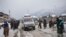 An ambulance ferries patients to a hospital through a snow-covered road in Kangan, north of Srinagar, India-controlled Kashmir, Jan. 14, 2020.