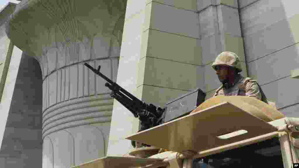 An Egyptian Army soldier takes his position on top of an armored vehicle as he guards in front of the Supreme Constitutional court in Cairo, August 19, 2013.