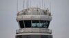 A man gestures inside the control tower of Reagan National Airport after an American Airlines flight crashed into the river after colliding with a US Army helicopter, near Washington, DC, on January 30, 2025.