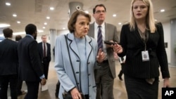 Sen. Dianne Feinstein, D-Calif., the ranking member on the Senate Judiciary Committee, takes a reporter's question as she walks to the Senate for a vote, at the Capitol in Washington, Jan. 11, 2018.