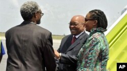 South African president Jacob Zuma (C), flanked by South African ambassador to Ivory Coast Lallie Ntombizodwa (R), shakes hands with African Union representative to Ivory Coast Ambroise Niyonsaba (L) as he arrivesat Abidjan international airport on Februa