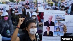 NagaWorld Casino workers hold up placards during a protest outside the National Assembly building after several union members were arrested, in Phnom Penh, Cambodia, on January 4, 2022. REUTERS/Cindy Liu
