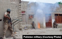 In an undated photo, Pakistani troops are shown raiding and searching suspected militant places in North Waziristan during the so-called "Zarb-e-Azb" counter-militancy operations.