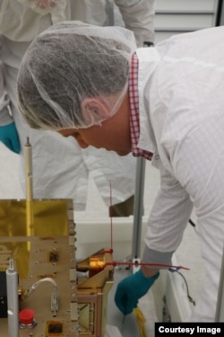 Cal Poly CubeSat engineer Ryan Nugent works with the Prox-1 spacecraft following LightSail 2 final integration on 7 May 2019 at the Air Force Research Laboratory in Albuquerque, New Mexico. Prox-1 contains LightSail 2. (Photo: Air Force Research Laborator
