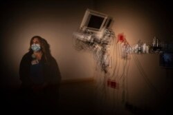 n this photo created with an in-camera multiple exposure, registered nurse Christina Anderson, part of a group of nurses who had been treating coronavirus patients in an intensive care unit, stands for a photo in the empty COVID-19 ICU at Providence.