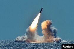 FILE PHOTO: An unarmed Trident II D5 missile is test-launched from the ballistic missile submarine USS Nebraska