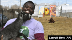This April 10, 2020 photo shows Marshall Mitchell, Urban Farm Assistant at the Urban Growers Collective farm in Chicago. The nonprofit teaches young kids and others to grow vegetables at eight urban farms around the city. (Laurell Sims via AP)