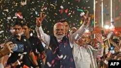 India’s Prime Minister Narendra Modi flashes victory sign as he arrives at the Bharatiya Janata Party (BJP) headquarters to celebrate the party’s win in country's general election, in New Delhi, June 4, 2024.