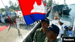 Personnel from the Vietnamese and Cambodian navies stand at attention as a national anthem is played onboard a cruiser during a handing-over ceremony at a Cambodian naval base in Sihanouk Ville, 210km (130 miles) southwest of Phnom Penh January 11, 2006. The Vietnamese government on Wednesday donated two cruisers to the Cambodian navy for sea patrols.