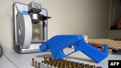 Un pistolet Liberator, à côté de l'imprimante 3D sur laquelle ses composants ont été fabriqués, le 11 juillet 2013.