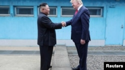 U.S. President Donald Trump shakes hands with North Korean leader Kim Jong Un as they meet at the demilitarized zone separating… FILE - U.S. President Donald Trump shakes hands with North Korean leader Kim Jong Un as they meet at the demilitarized zone se
