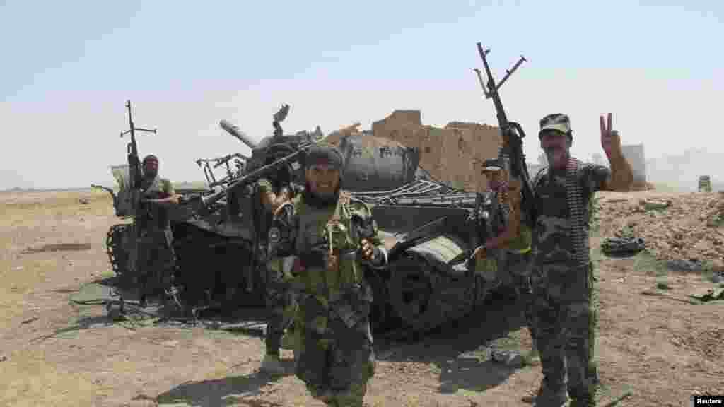 Iraqi Shiite militia fighters celebrate the defeat of Islamic State militants in Amerli, Iraq, Sept. 2, 2014.