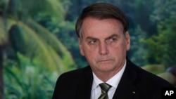 FILE - President Jair Bolsonaro attends a ceremony at the Planalto presidential palace in Brasilia, Brazil, Oct. 1, 2019.