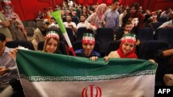 Iranians watch the World Cup Group B soccer match between Morocco and Iran at Azadi cinema in Tehran, June 15, 2018.