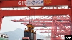 A crane loads a container onto a truck at Lianyungang Port in Lianyungang in China's eastern Jiangsu province on September 7, 2021.