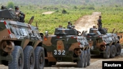 China's army soldiers sit on their tanks as they attend the opening of military exercise in Kampong Speu province, Cambodia, March 17, 2018. Hundreds of soldiers began a 15-day joint military exercise this week.