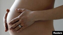 A pregnant woman, in the last trimester of her pregnancy, poses in this illustration photo in Sete, South France, March 26, 2016. REUTERS/Regis Duvignau