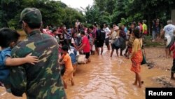 អ្នកភូមិ​យួរ​របស់​របរ​របស់​ខ្លួន គ្រាដែល​ពួកគេ​ត្រូវ​បាន​ជម្លៀស​ពី​ផ្ទះ​សម្បែង​ ​ក្រោយ​ការបាក់​ទំនប់​វារី​អគ្គិសនី Xepian-Xe Nam Noy នៅក្នុង​ខេត្ត Attapeu នៃ​ប្រទេស​ឡាវ នៅ​ថ្ងៃទី ២៤ ខែកក្កដា ឆ្នាំ២០១៨។ 