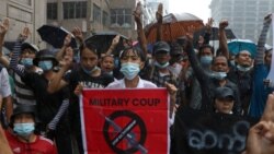 Anti-coup protesters flash the three-finger salute and chant slogan during the demonstration against the military coup in the rain at Pabedan township in Yangon, Myanmar, Friday, April 30, 2021. (AP Photo/Vincent Thian)