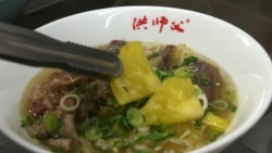 Chef Hung cooks pineapple beef noodle at his restaurant in Taipei, Taiwan, Wednesday, March 10, 2021. (AP Photo/Chiang Ying-ying)