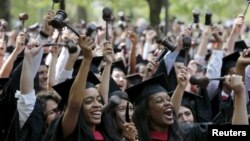 Students graduating from the School of Law cheer as they receive their degrees during the 364th Commencement Exercises at Harvard University in Cambridge, Massachusetts May 28, 2015. REUTERS/Brian Snyder - RTX1EZC9