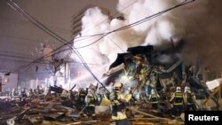 Firefighters operate at the site where a large explosion occurred at a restaurant in Sapporo, Hokkaido, northern Japan, in this photo taken by Kyodo, Dec. 16, 2018. 