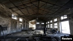 FILE - A closed brick factory building is seen on the outskirts of Beijing, China, Jan. 18, 2016. Chinese manufacturing ebbed in January to its lowest in more than three years, a possible sign of further weakness in the world's No. 2 economy.