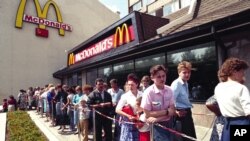 FILE - In this photo taken in 1991, Russians wait in line outside a McDonald's fast food restaurant in Moscow.
