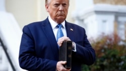 FILE - President Donald Trump holds a Bible as he visits outside St. John's Church across Lafayette Park from the White House, June 1, 2020.