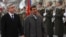 Armenian President Serzh Sargsyan (L) walks with Iran's President Mahmoud Ahmadinejad (C) during an official welcoming ceremony in Yerevan, Dec. 23, 2011. 