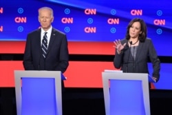 Democratic presidential hopeful U.S. Senator from California Kamala Harris delivers her closing statement flanked by former Vice President Joe Biden during the Democratic primary debate hosted by CNN at the Fox Theatre in Detroit, July 31, 2019.