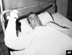 FILE - U.S. Navy Lt. Cmdr. John S. McCain lies injured in North Vietnam wearing an arm cast, in this undated photo.