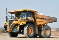 Tene Konate, 42, a truck driver, climbs on her dumper truck at the gold mine site in Hounde, Burkina Faso February 12, 2020