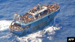 This image released by The Hellenic Coastguard on June 14, 2023, shows an aerial view taken from a rescue helicopter, of migrants onboard a fishing vessel in the waters off the Peloponnese coast of Greece on June 13, 2023.