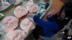 An employee adds details to rubber masks depicting President-elect Joe Biden at the Ogawa Studios in Saitama, north of Tokyo, Wednesday, Nov. 11, 2020. Ogawa Studios, a Japanese manufacturer started making the masks since the middle of October,…