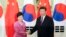 Chinese President Xi Jinping (R) shakes hands with South Korean President Park Geun-hye at the Great Hall of the People in Beijing, Sept. 2, 2015.