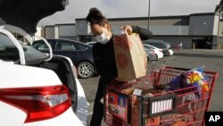 Instacart worker Saori Okawa loads groceries into her car for home delivery in San Leandro, Calif., July 1, 2020. Okawa is one of an estimated 1.5 million so-called gig workers.