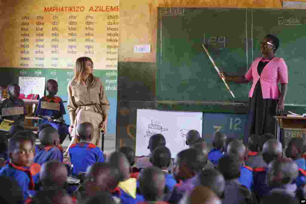 First lady Melania Trump sits with a student during language class as she visits Chipala Primary School, in Lilongwe, Malawi, Oct. 4, 2018. 